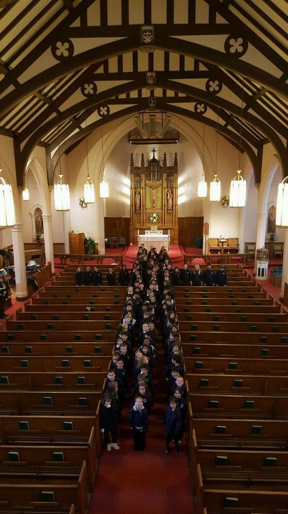 Children walking down the aisle of a church