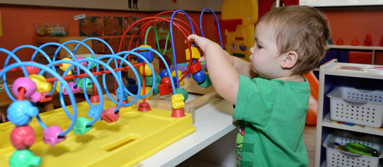 Child playing with a bead maze toy