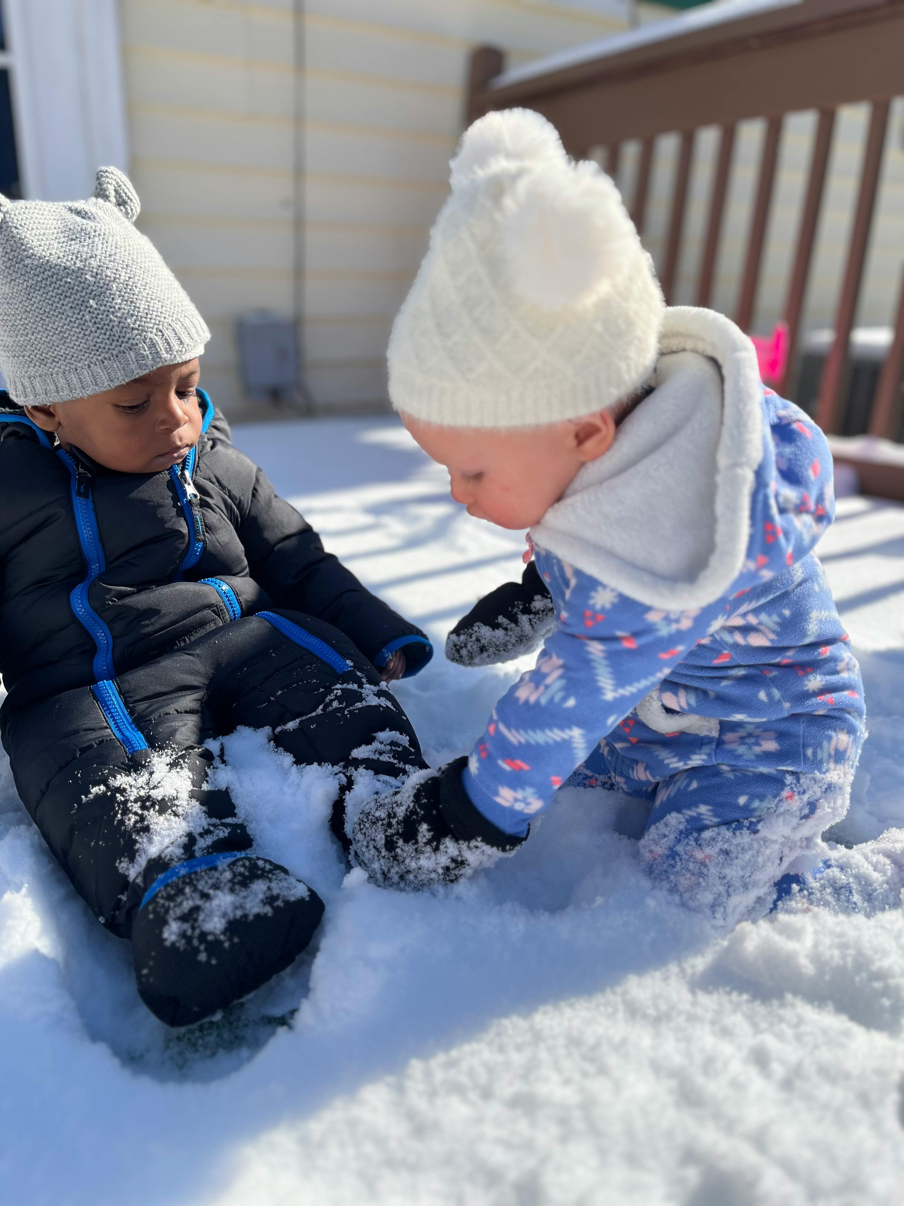 Two children playing in the snow