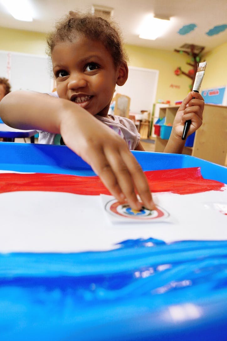 Child crafting with paint at a table