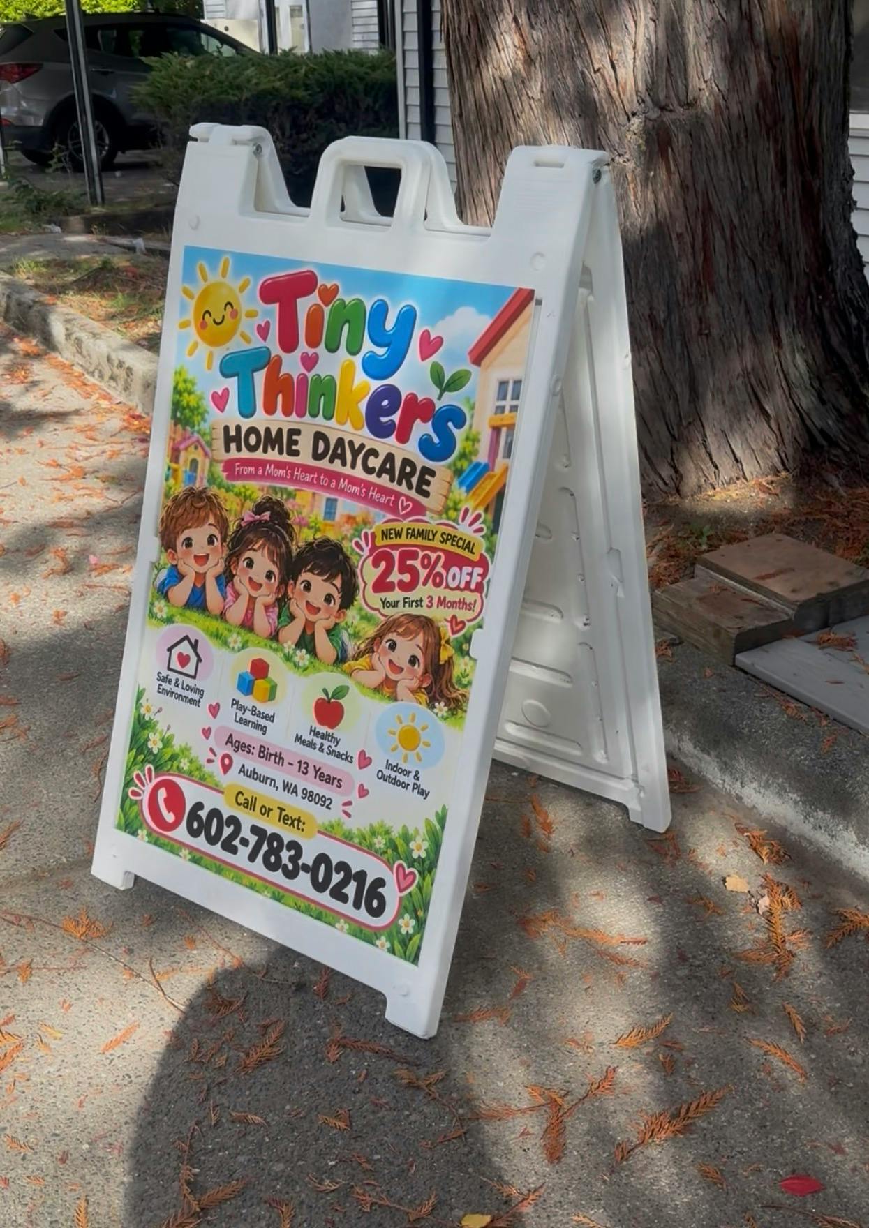 A-frame sign for Tiny Thinkers Home Daycare advertising services and contact info