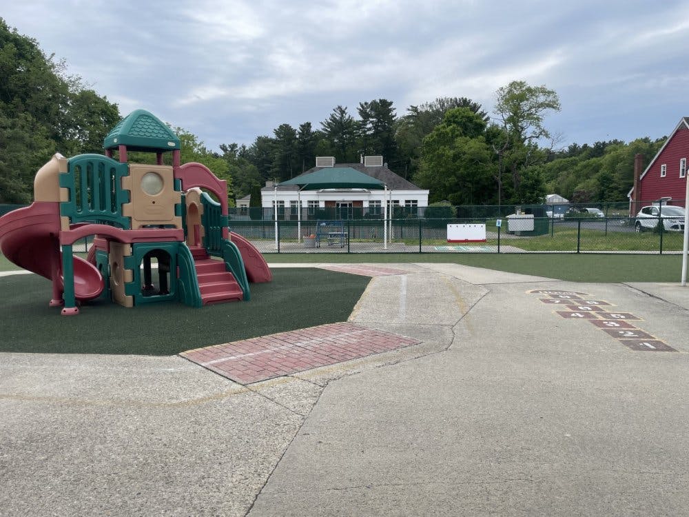 Playground with a colorful play structure and hopscotch on the ground