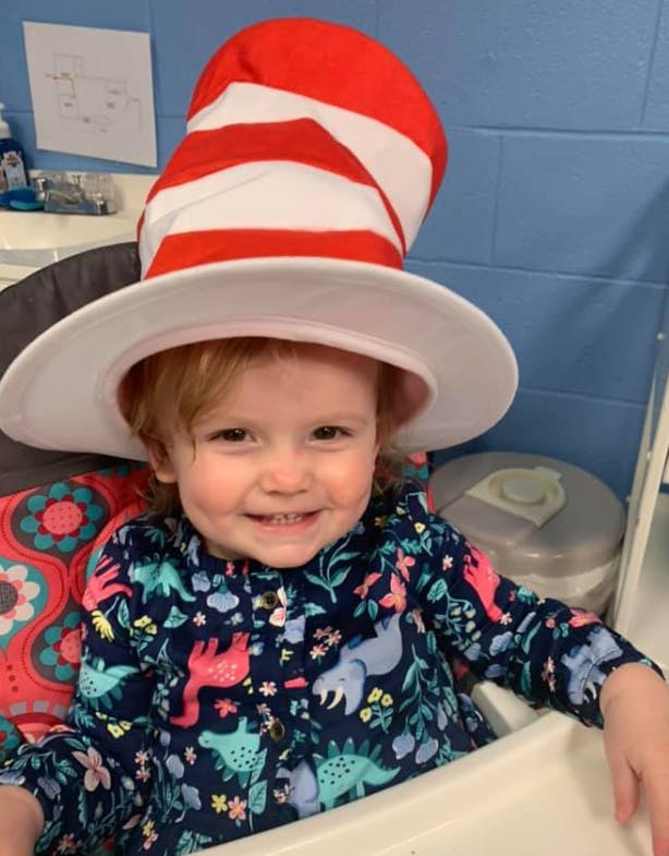 Child wearing a red and white striped hat