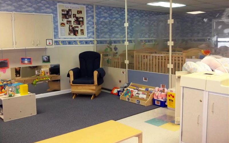 Classroom with cribs, a rocking chair, toys, and changing station
