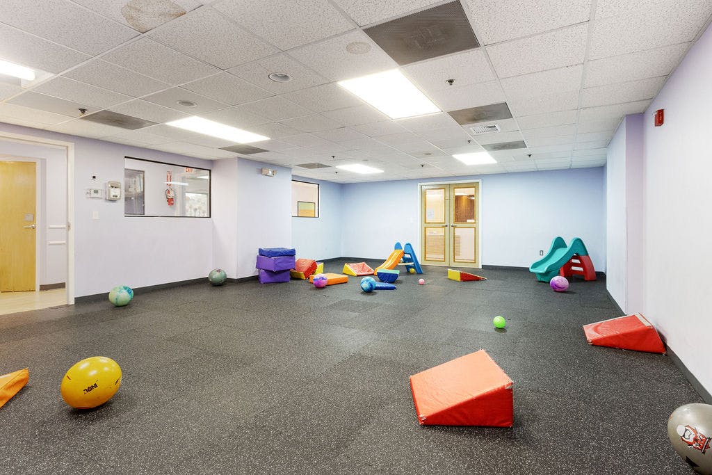 Playroom with various colorful toys and soft play equipment