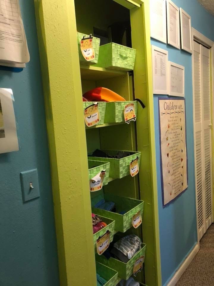 Open closet with green shelves and green storage bins