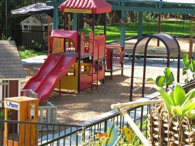 Playground with red slides and play structure