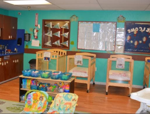 Nursery room with cribs, changing tables, and a play area