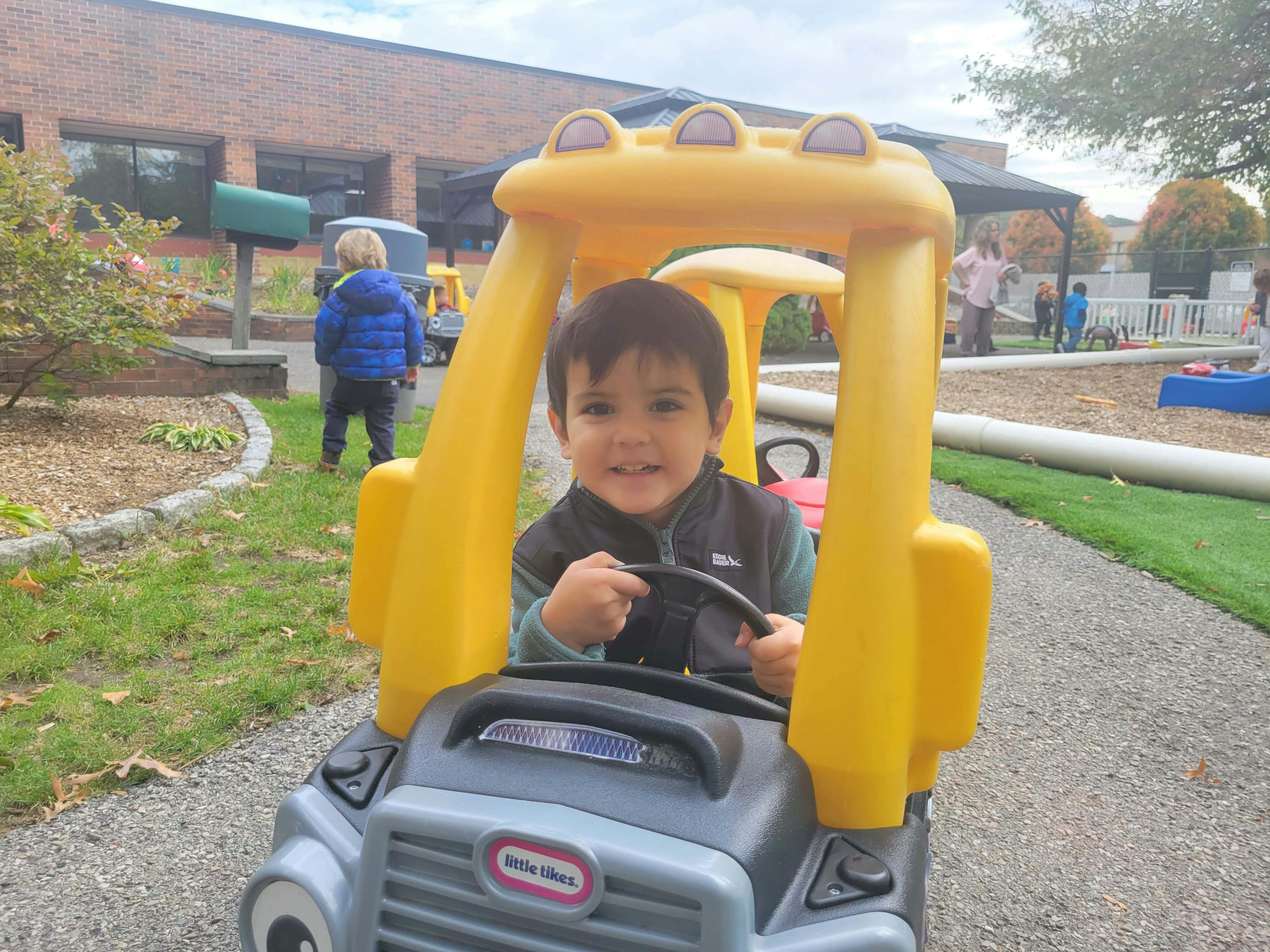 Child in a toy car on a playground