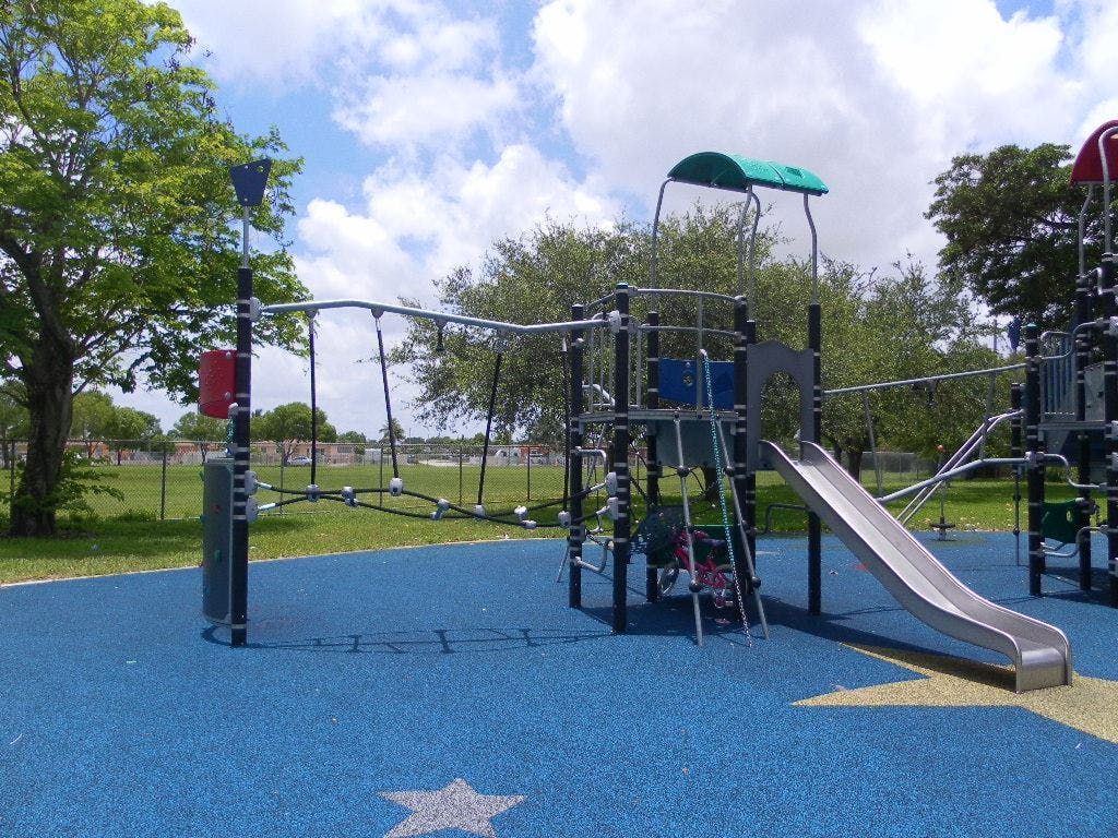 Playground with slide and climbing structures on blue ground
