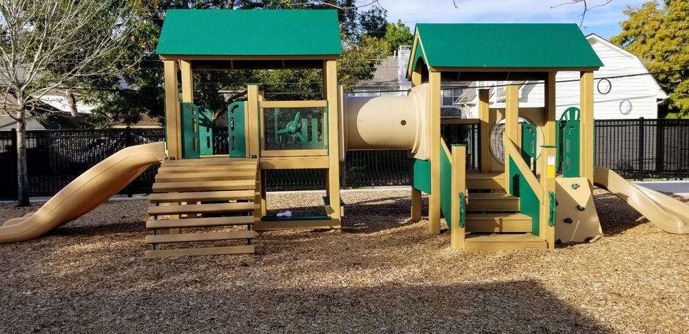 Playground structure with slides, stairs, and a tunnel