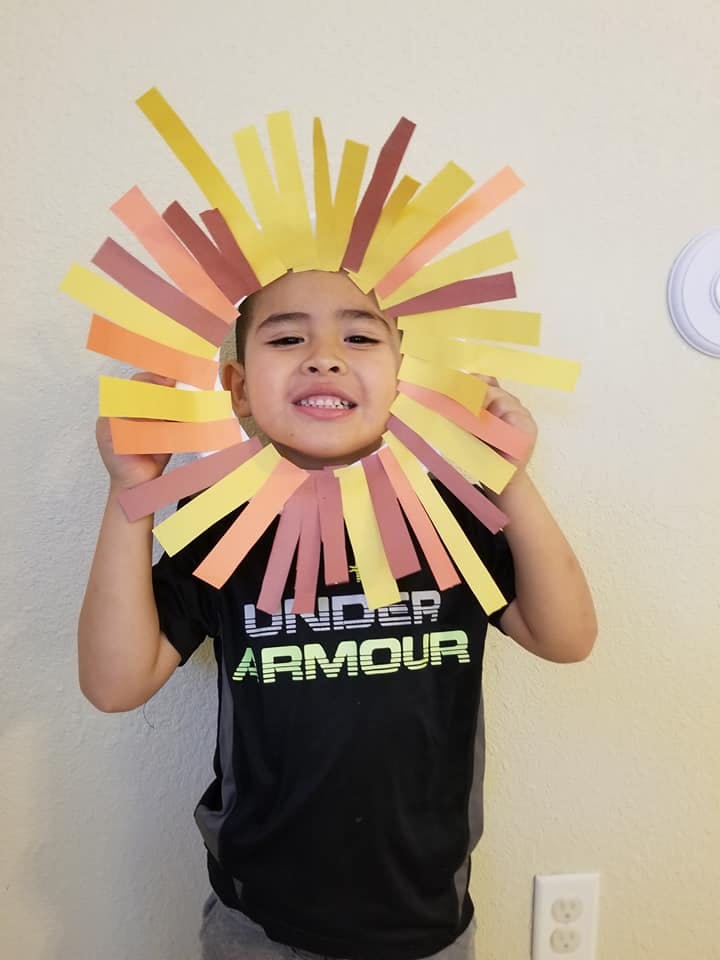 Child wearing a paper lion's mane