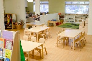 Empty classroom with small tables and chairs