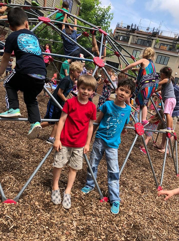 Children playing on a geodesic dome climber