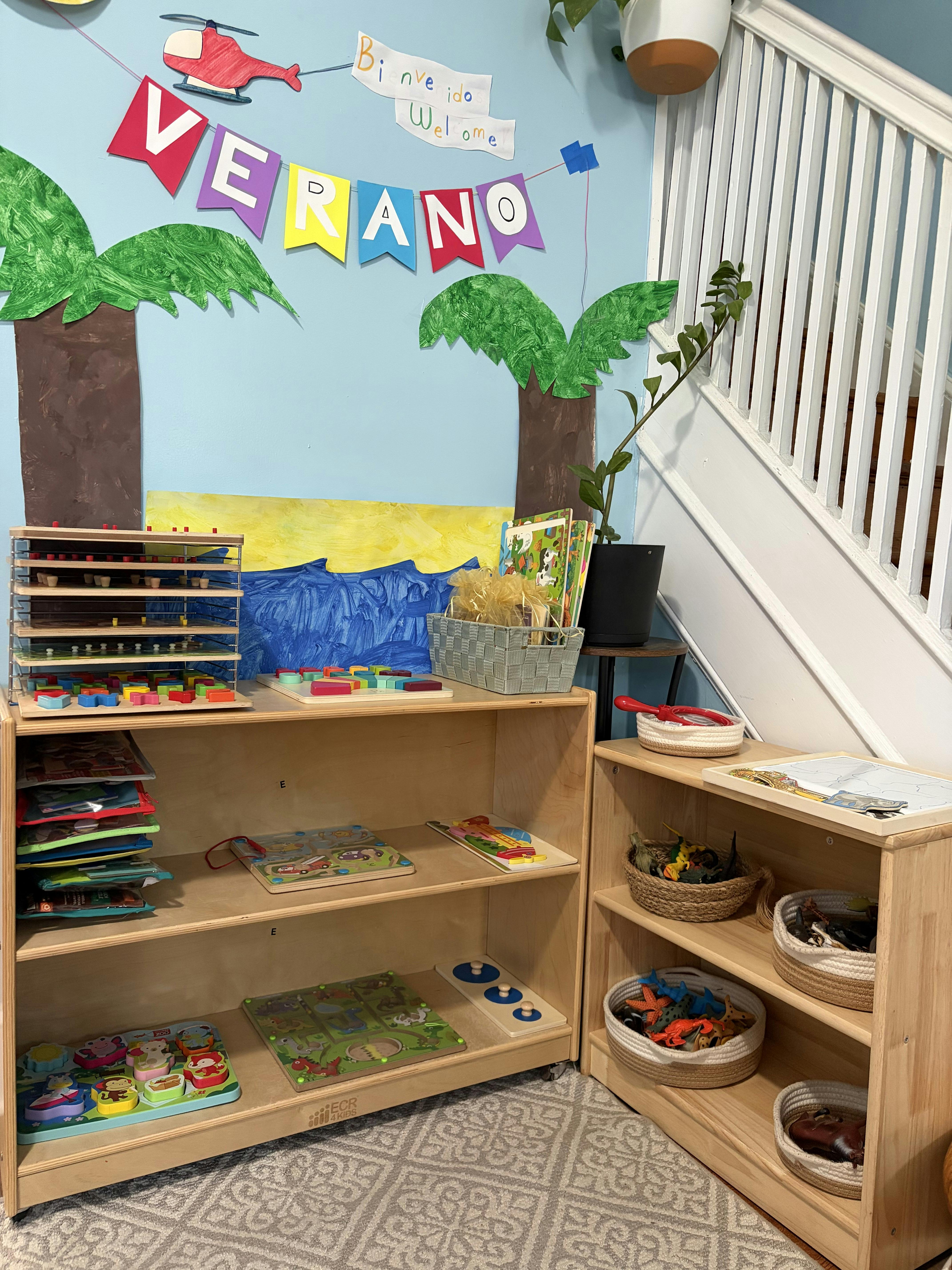Wooden shelves with children's toys and puzzles against a decorated wall