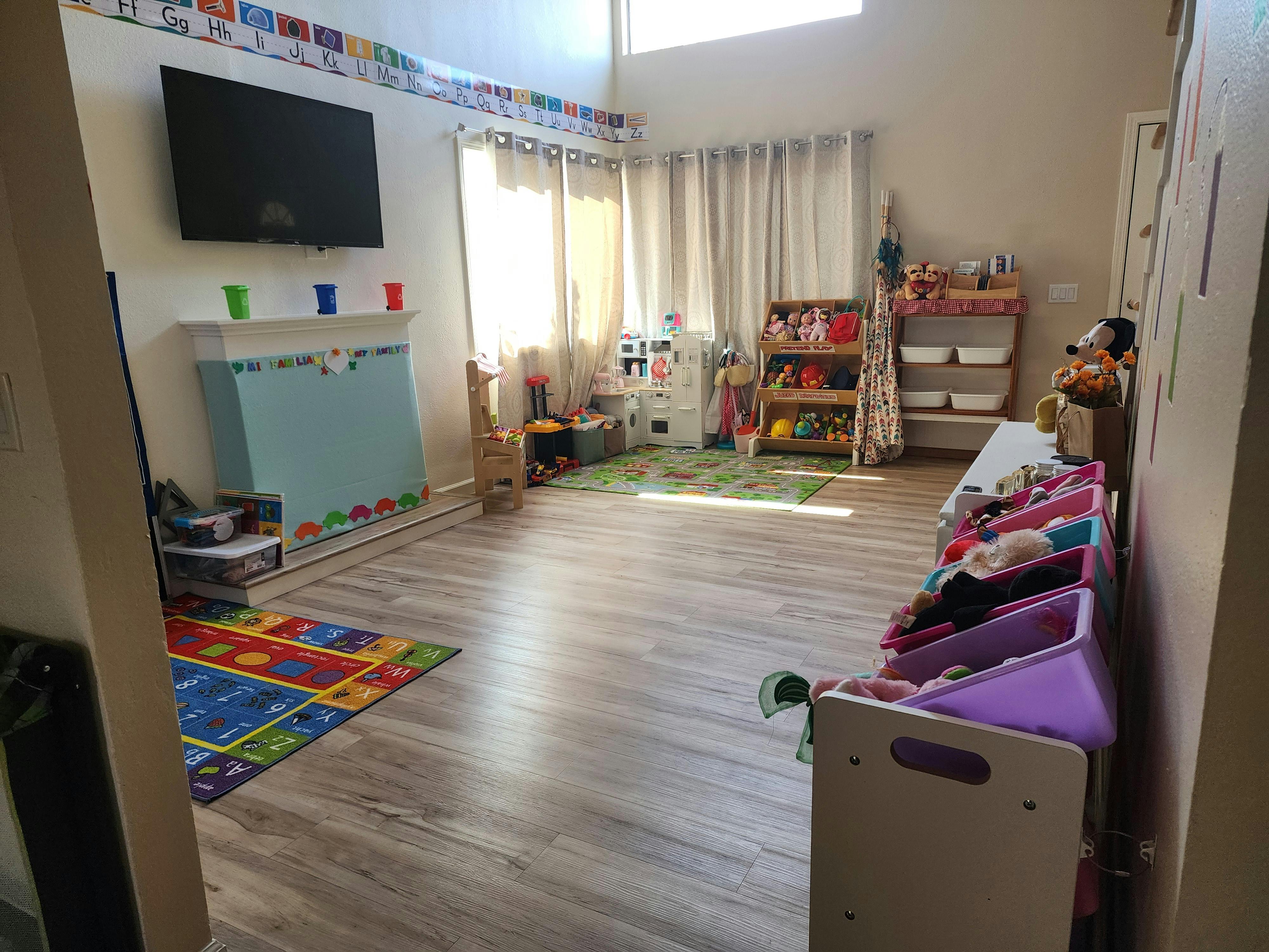 Playroom with toys, shelves, and a television