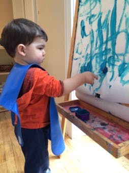 Child painting on an easel