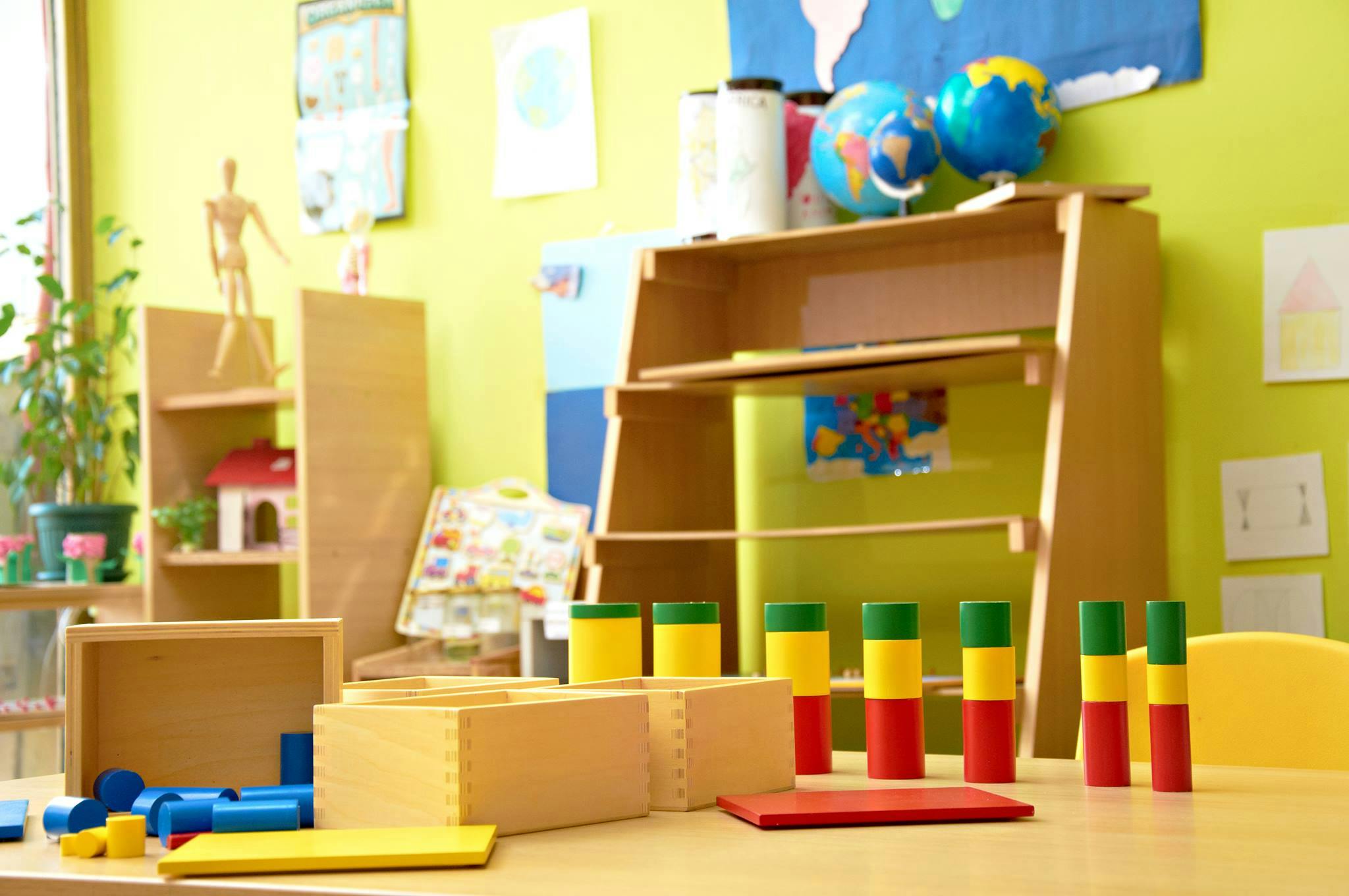 Classroom with wooden shelves, blocks, and learning materials