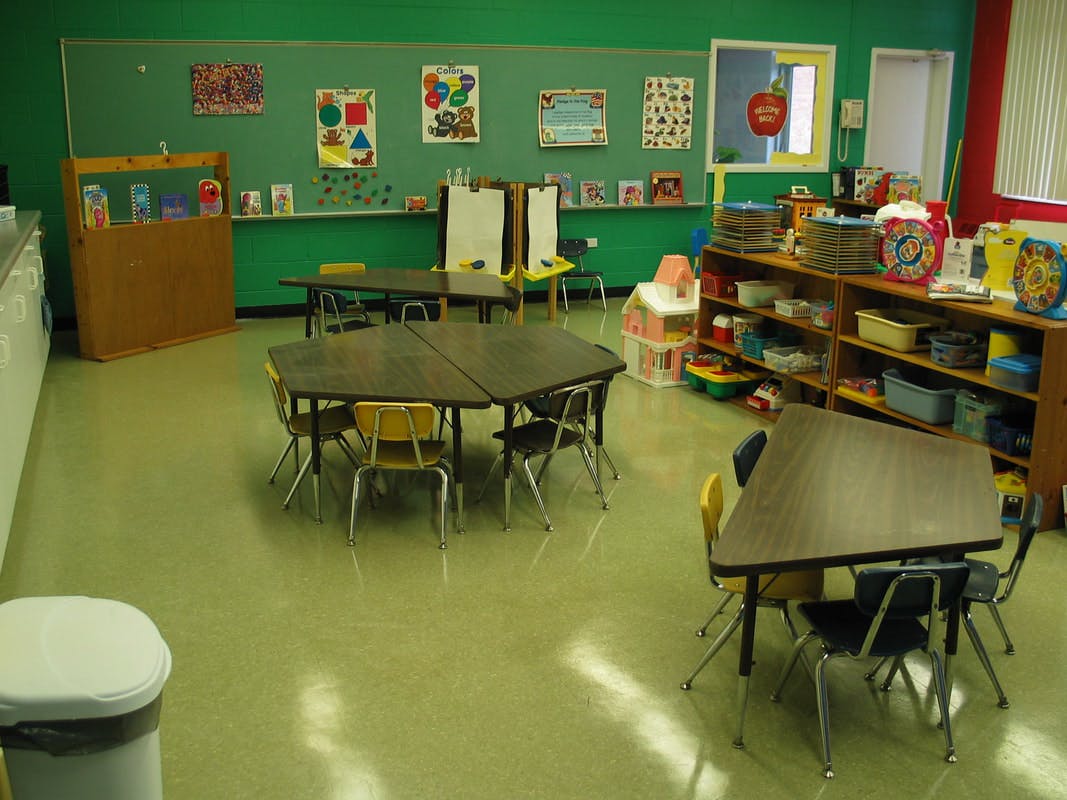 Empty classroom with small tables and chairs