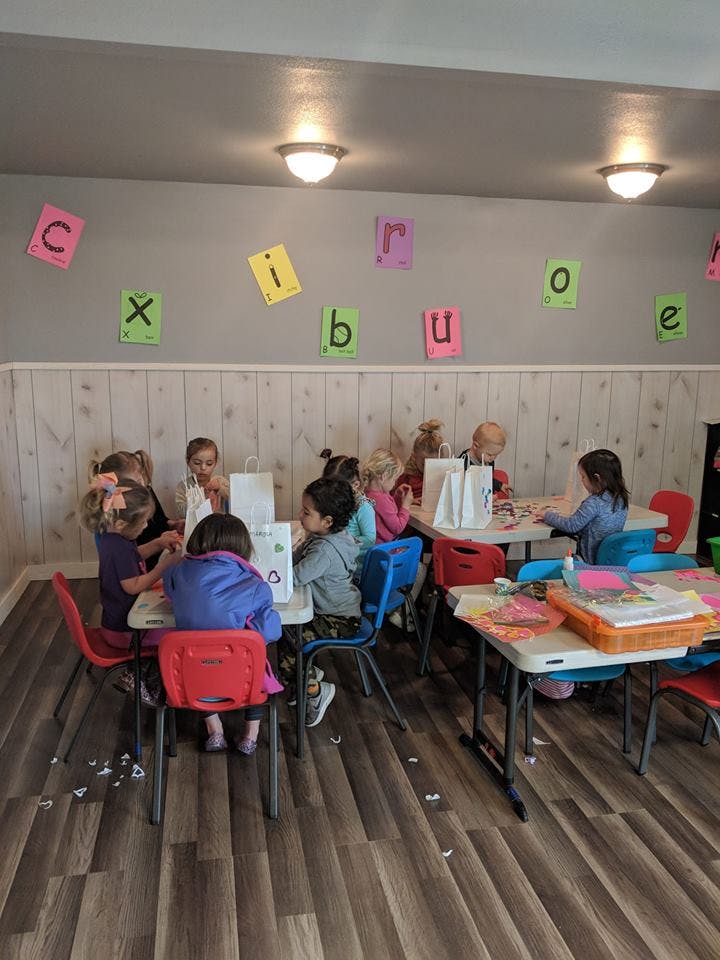 Children sitting at tables in a classroom