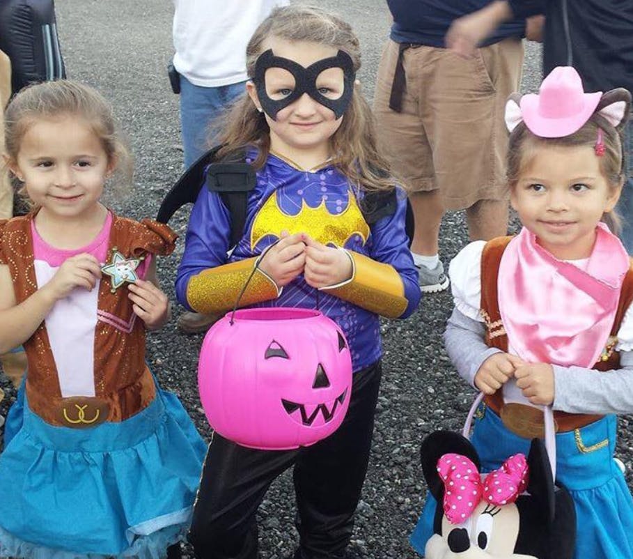 Three children in Halloween costumes