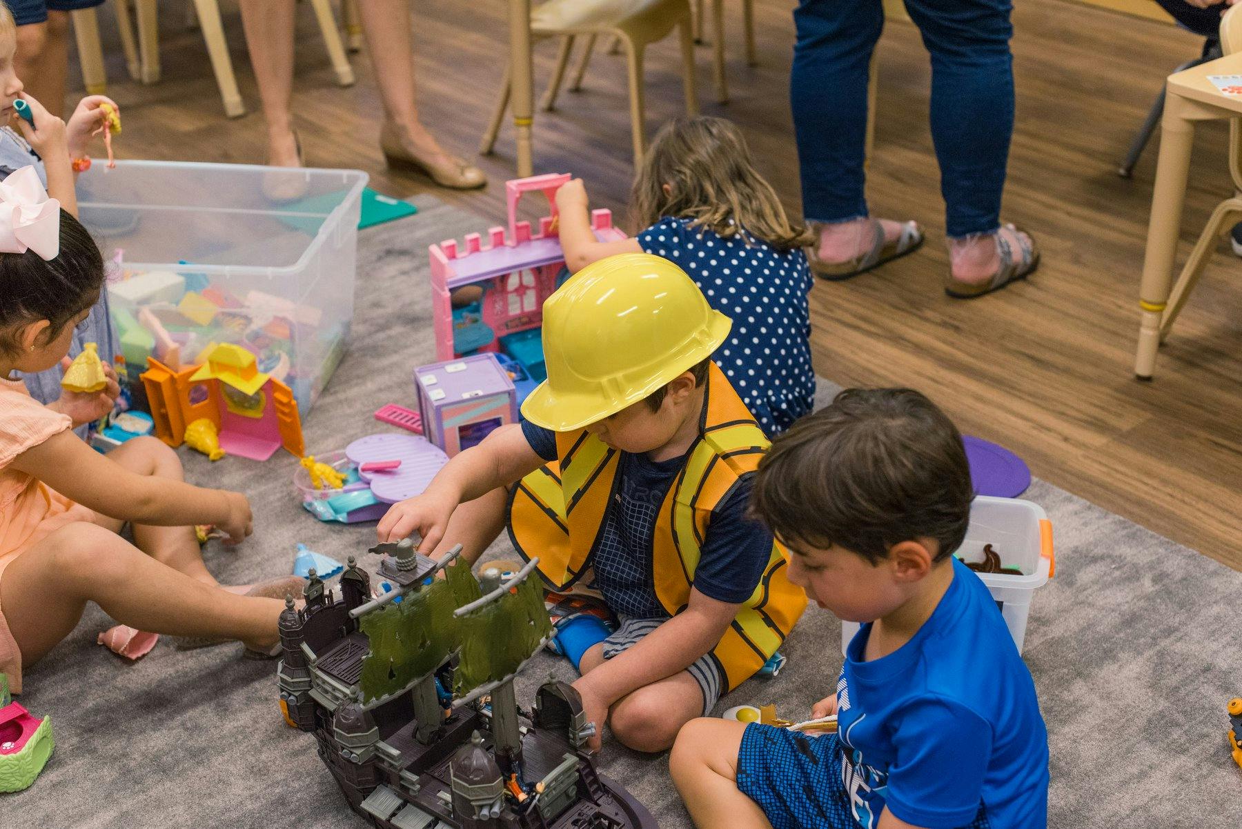 Children playing with toys on the floor