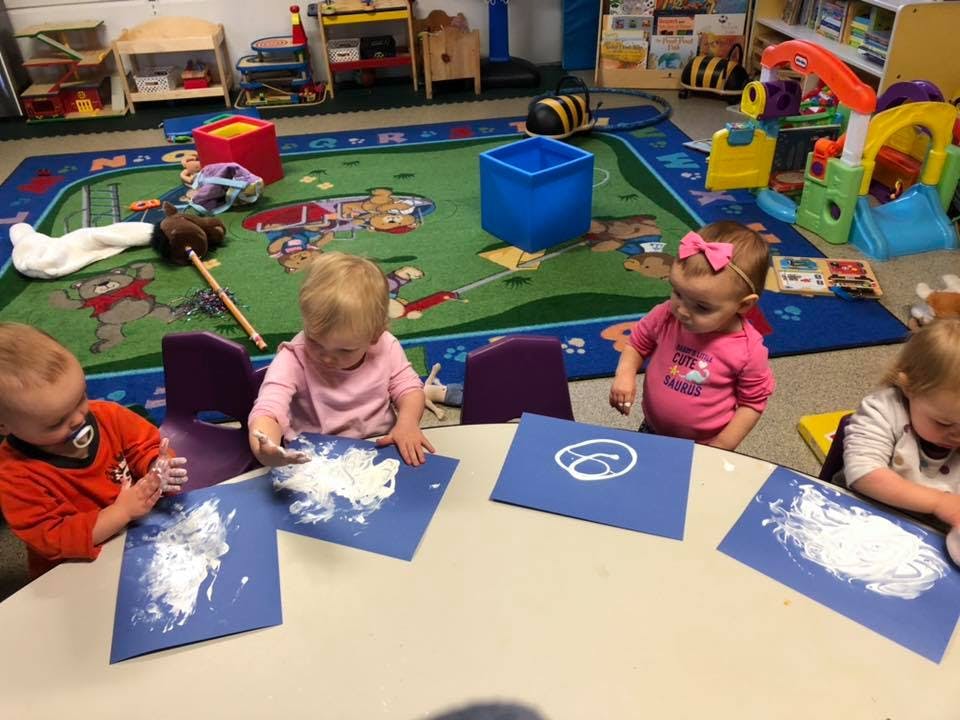 Children doing an art activity at a table