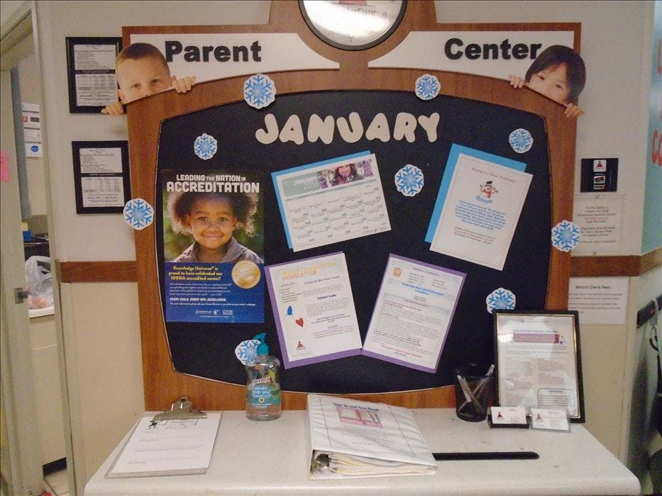 Parent Center bulletin board with January sign and child cutouts peering over top