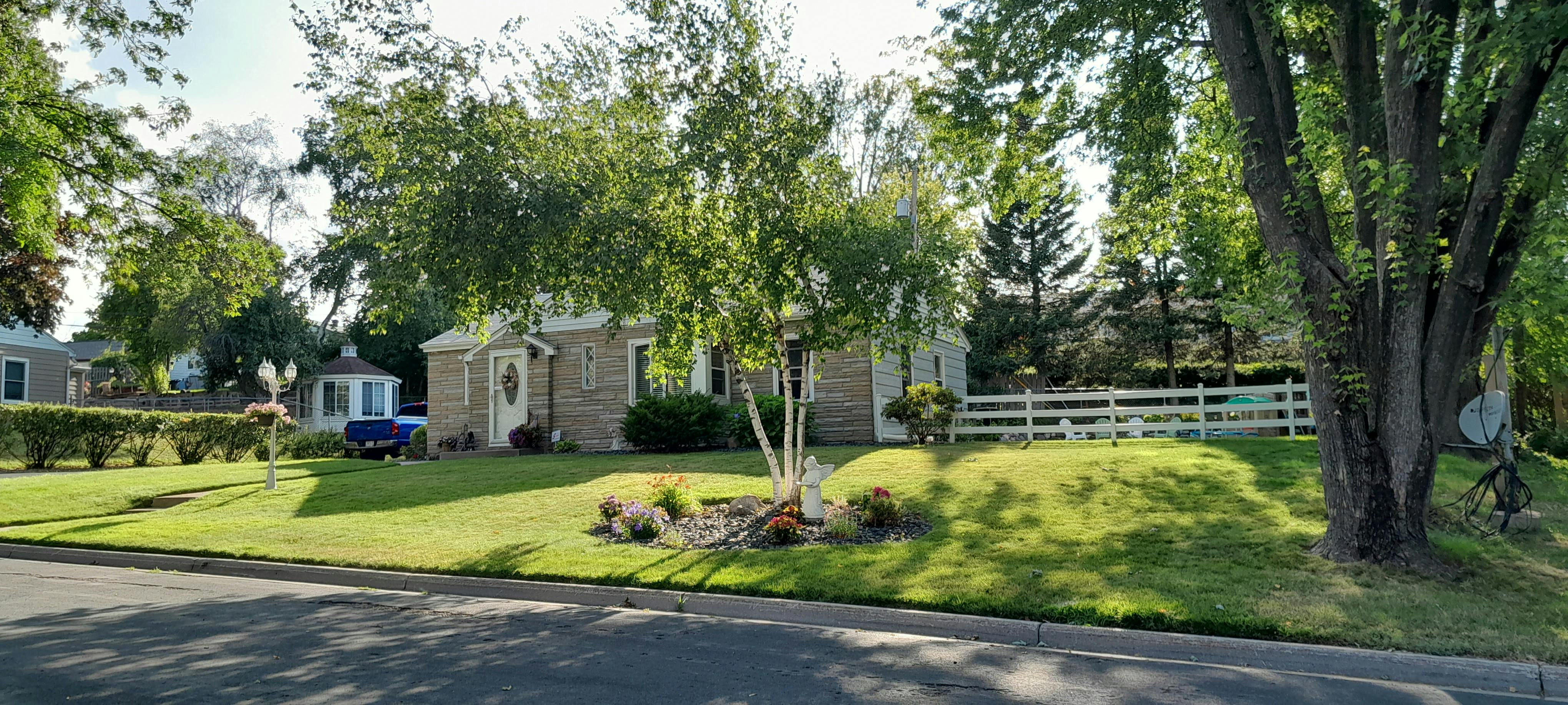 House with a green lawn and trees