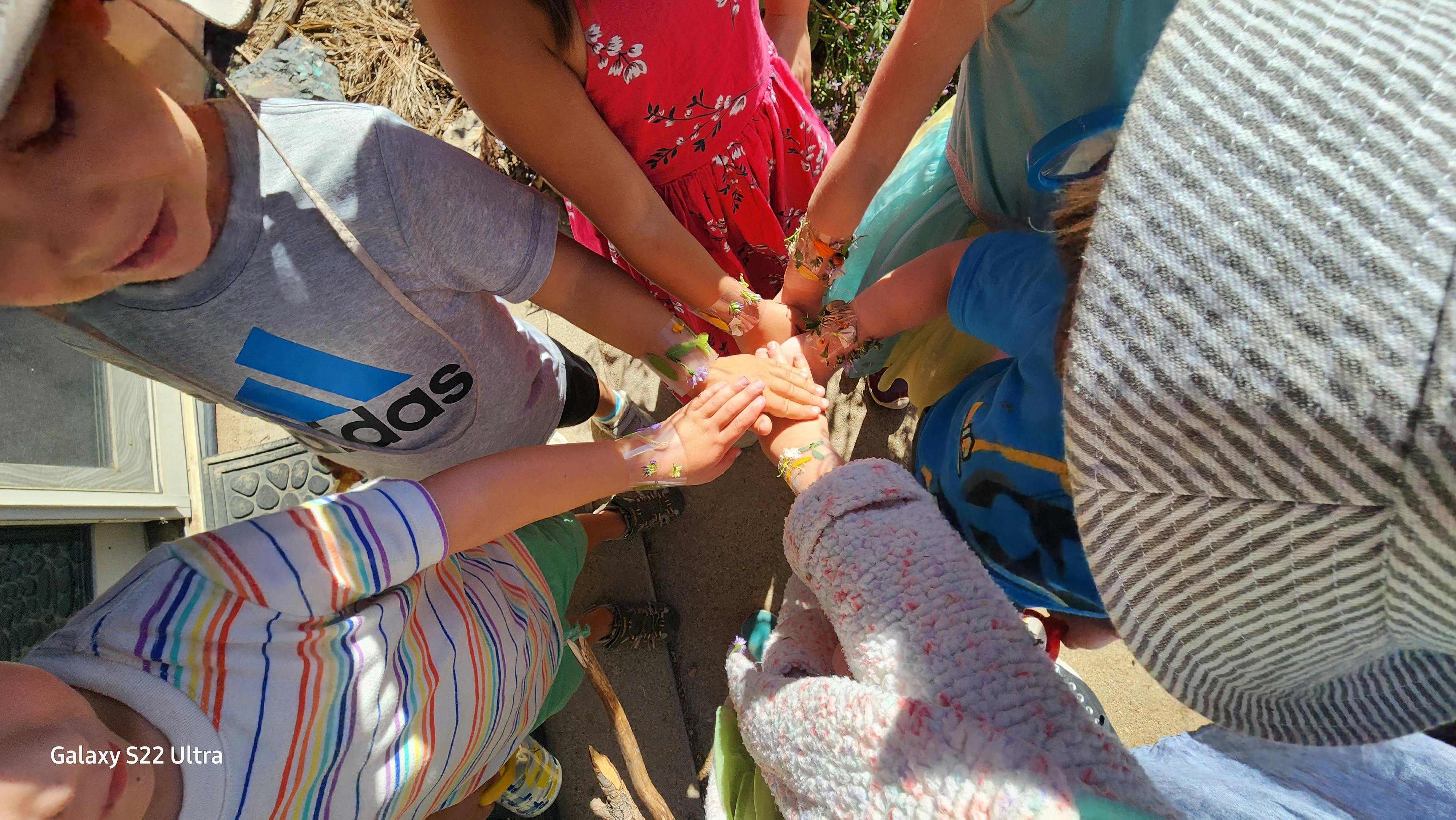 Children with hands together in a circle