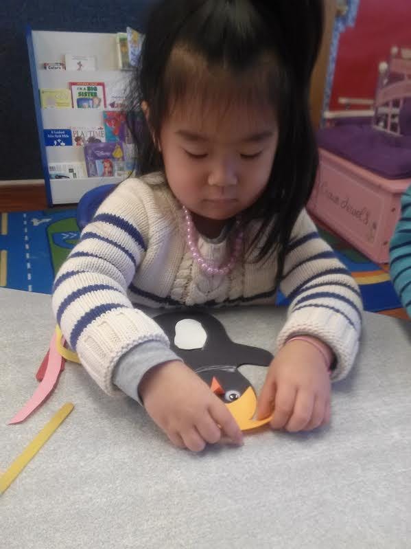 Child making a craft in a classroom
