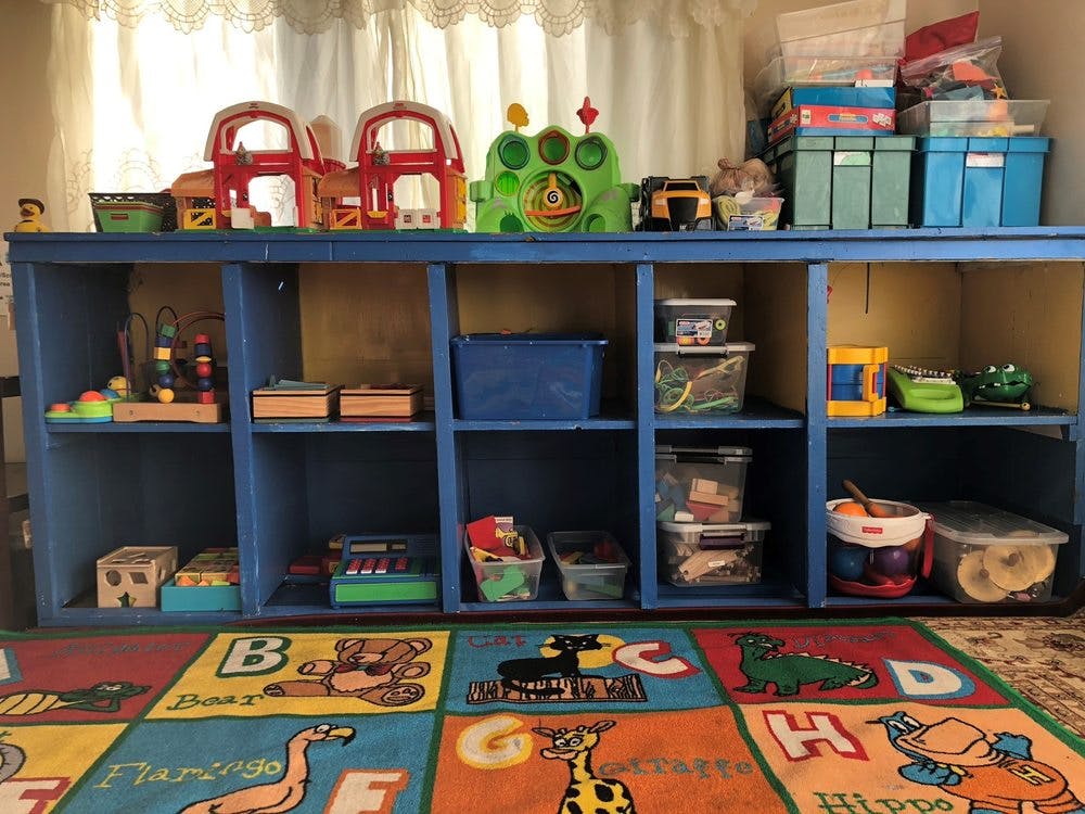 Blue shelving unit with toys and storage bins