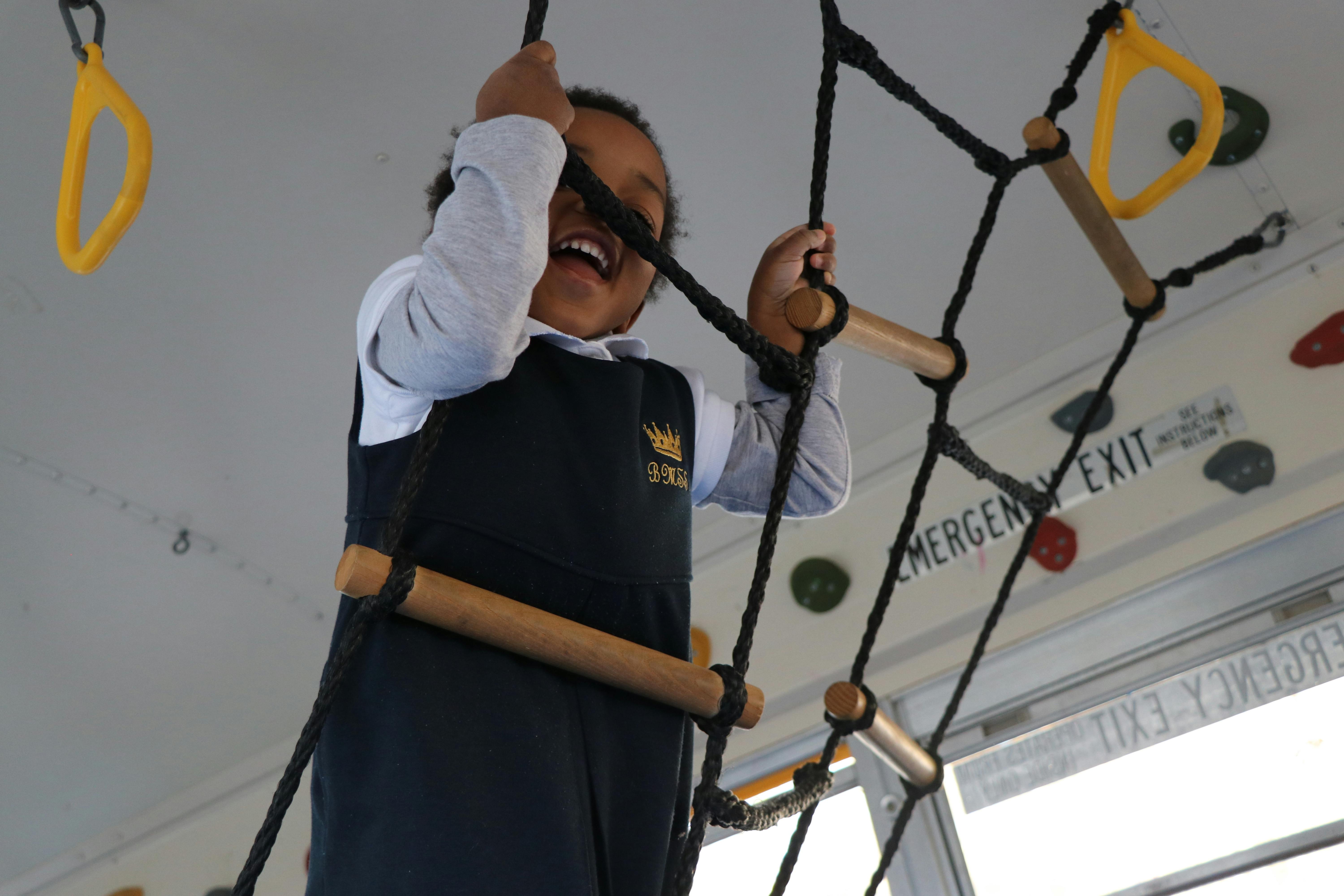 Child climbing a rope ladder