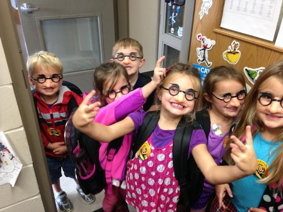 Group of children wearing novelty glasses with fake noses