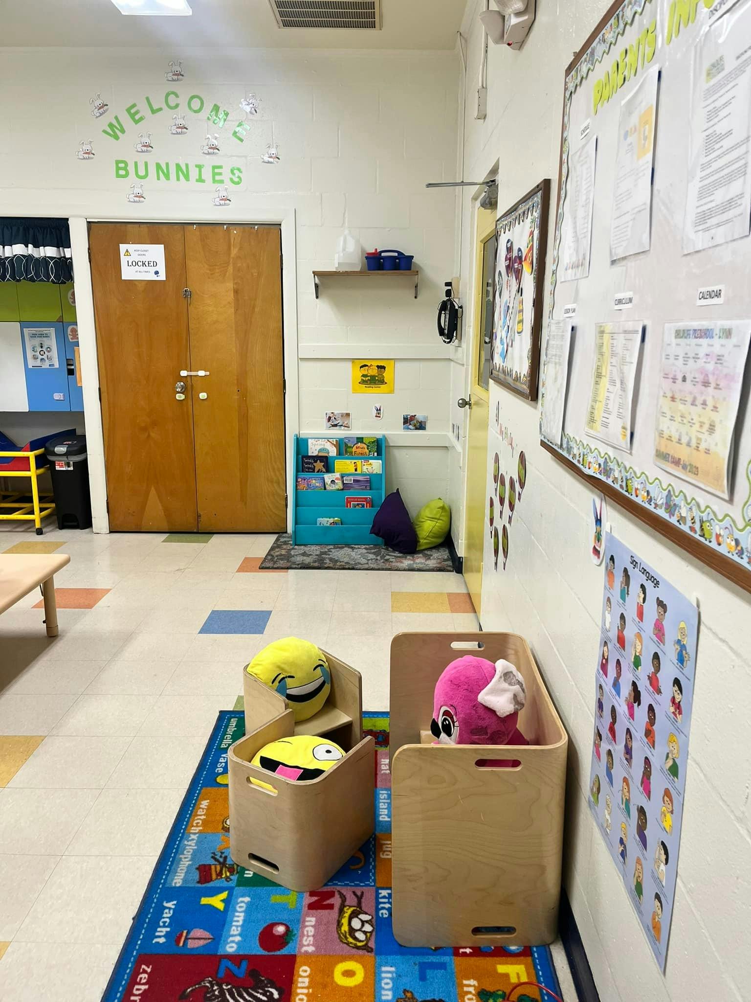 Children's classroom hallway with welcome sign and bulletin boards