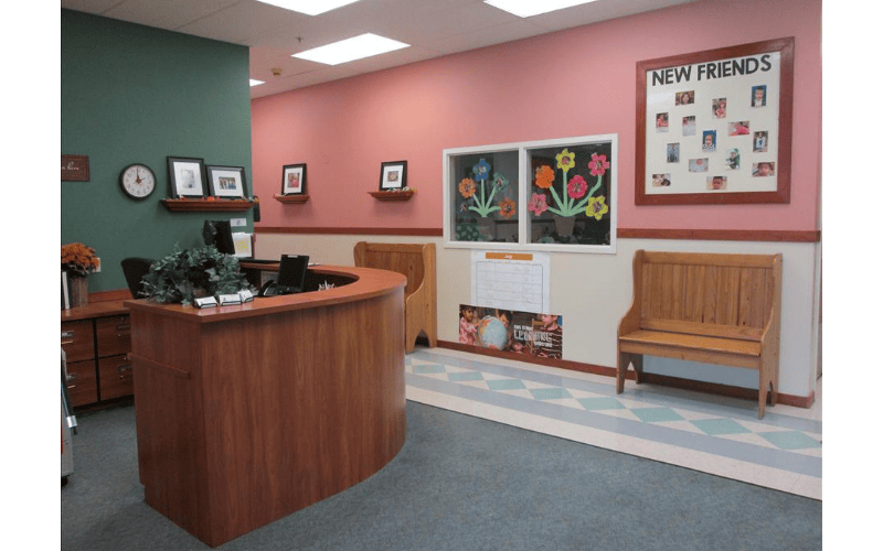 Reception desk with New Friends bulletin board in a school or daycare