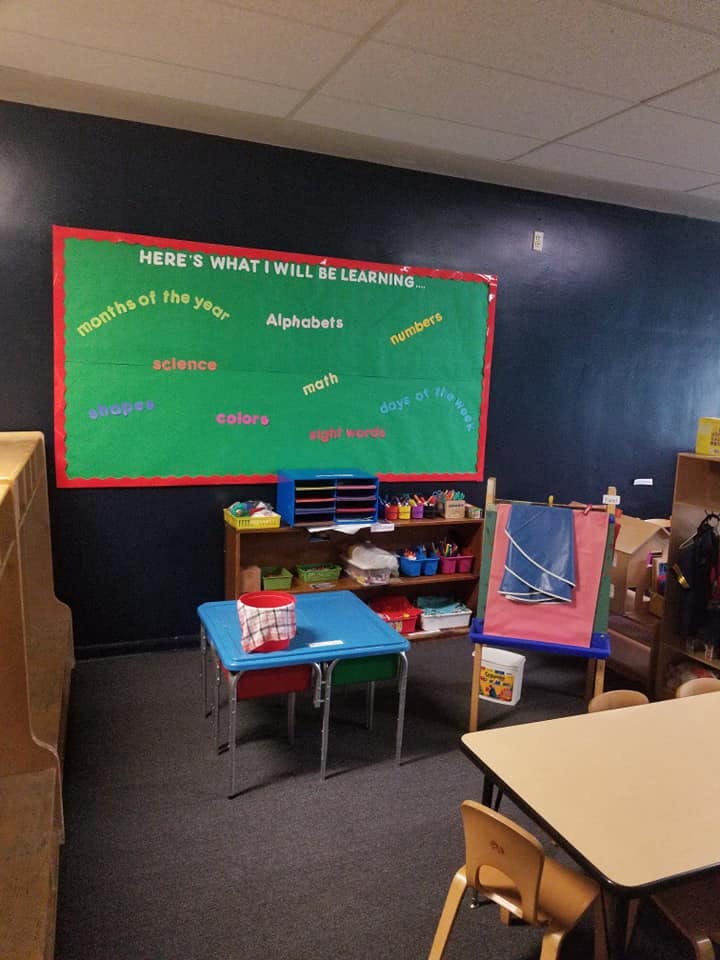 Classroom with a green bulletin board titled "Here's what I will be learning"