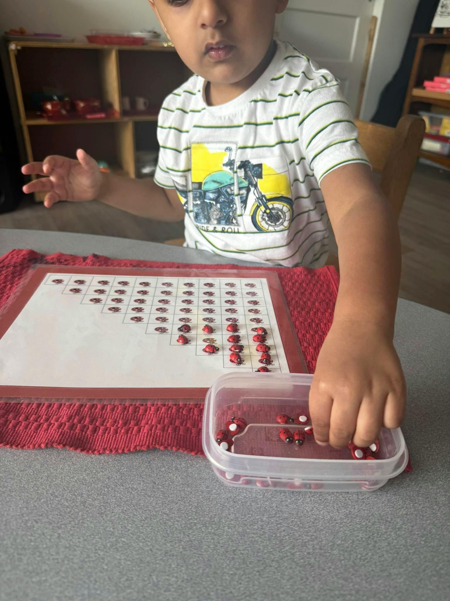 Child playing with ladybug counting game