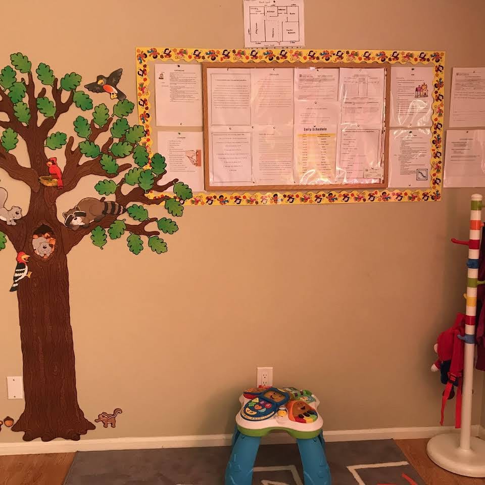 Tree mural with animals and a bulletin board in a classroom