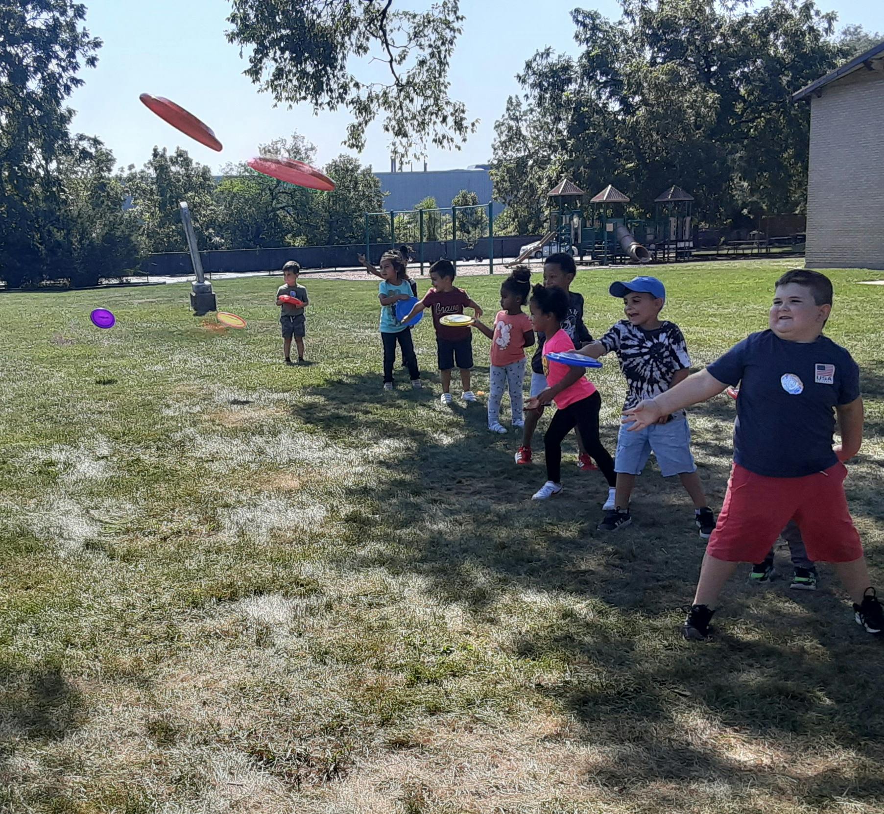 Children playing with frisbees outdoors