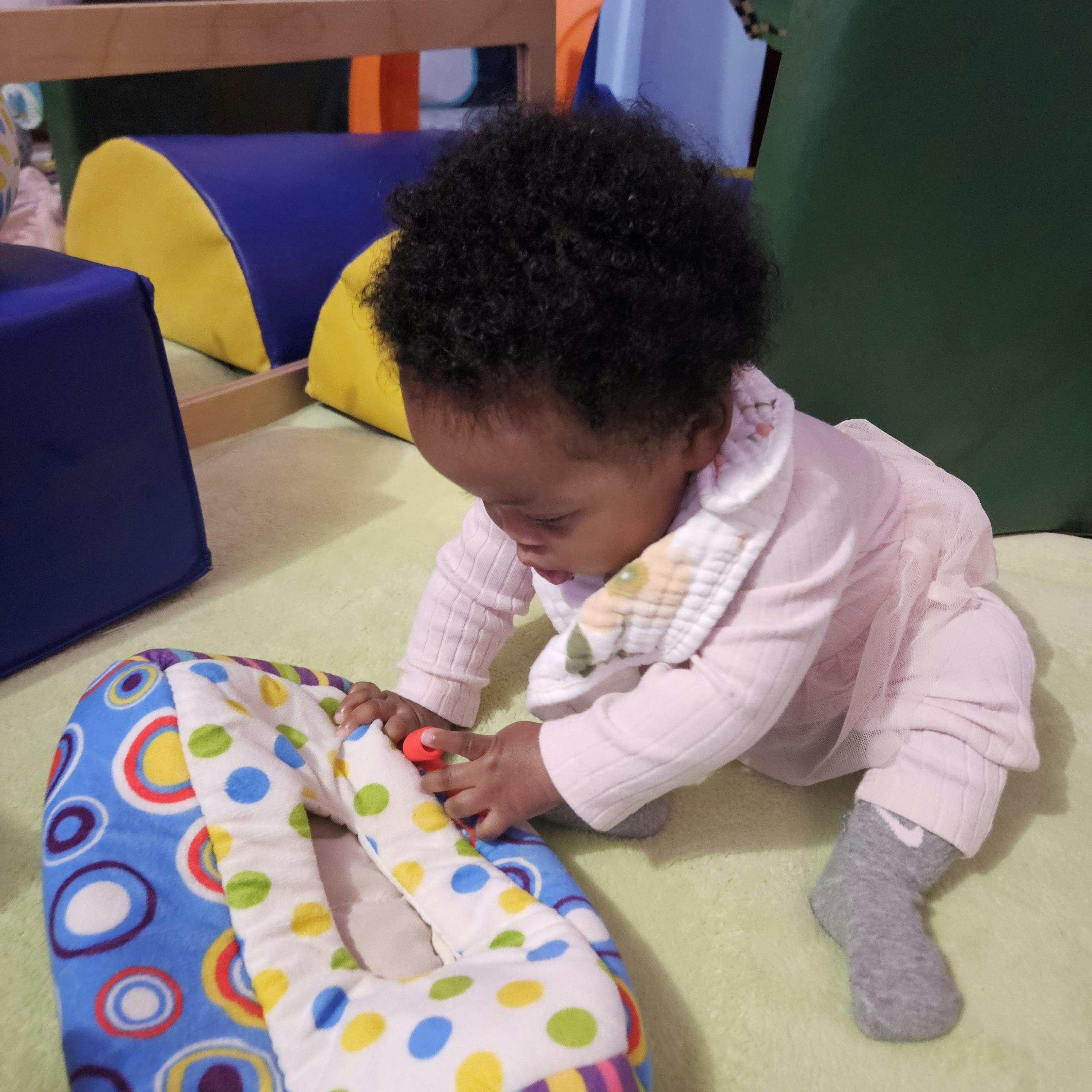 Child playing with a colorful toy