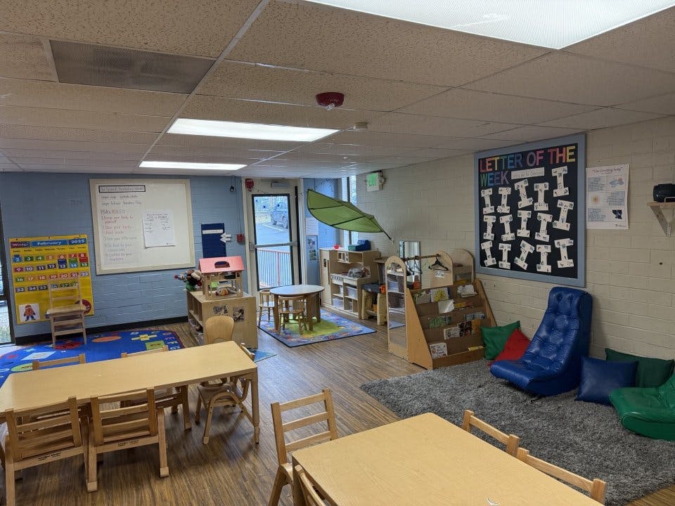 Classroom with tables, chairs, calendar, and "Letter of the Week" board