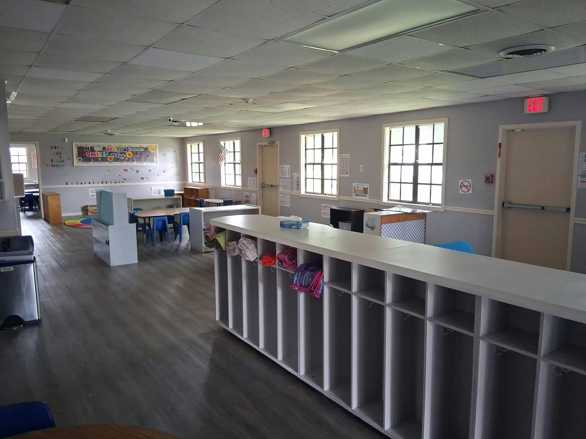Empty classroom with cubbies tables and chairs
