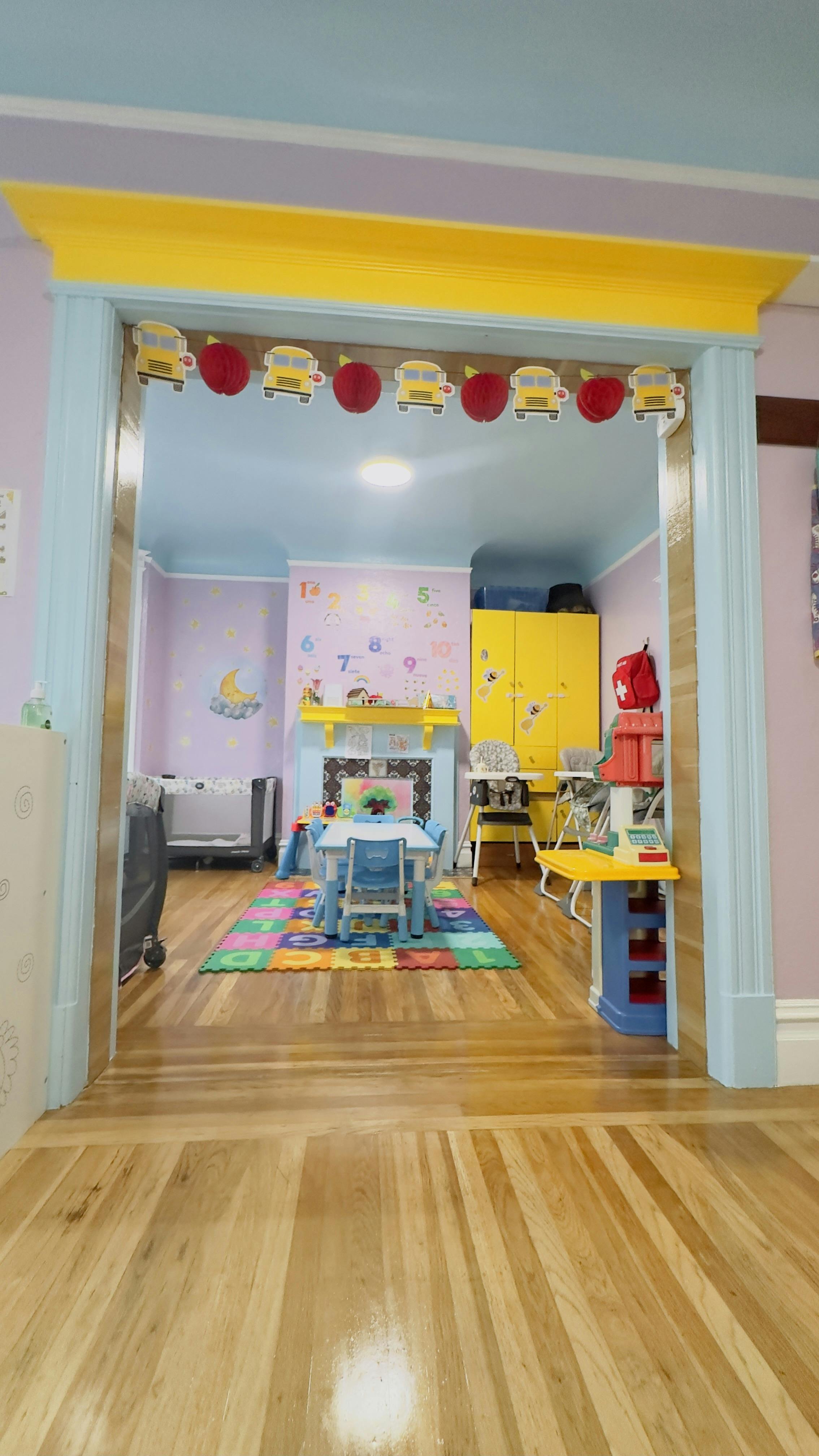 Colorful playroom with small table and chairs on a foam mat