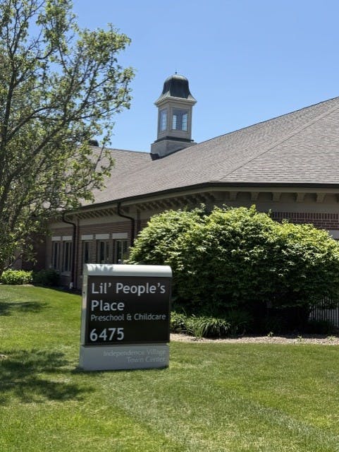 Sign for Lil' People's Place Preschool and Childcare in front of a building