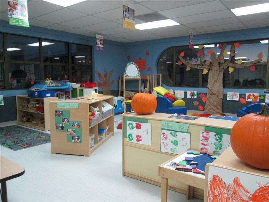 Classroom decorated for fall with pumpkins and a paper tree
