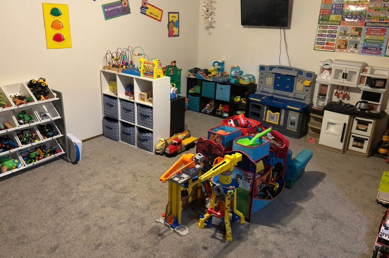 Playroom filled with various toy sets and organizational storage bins