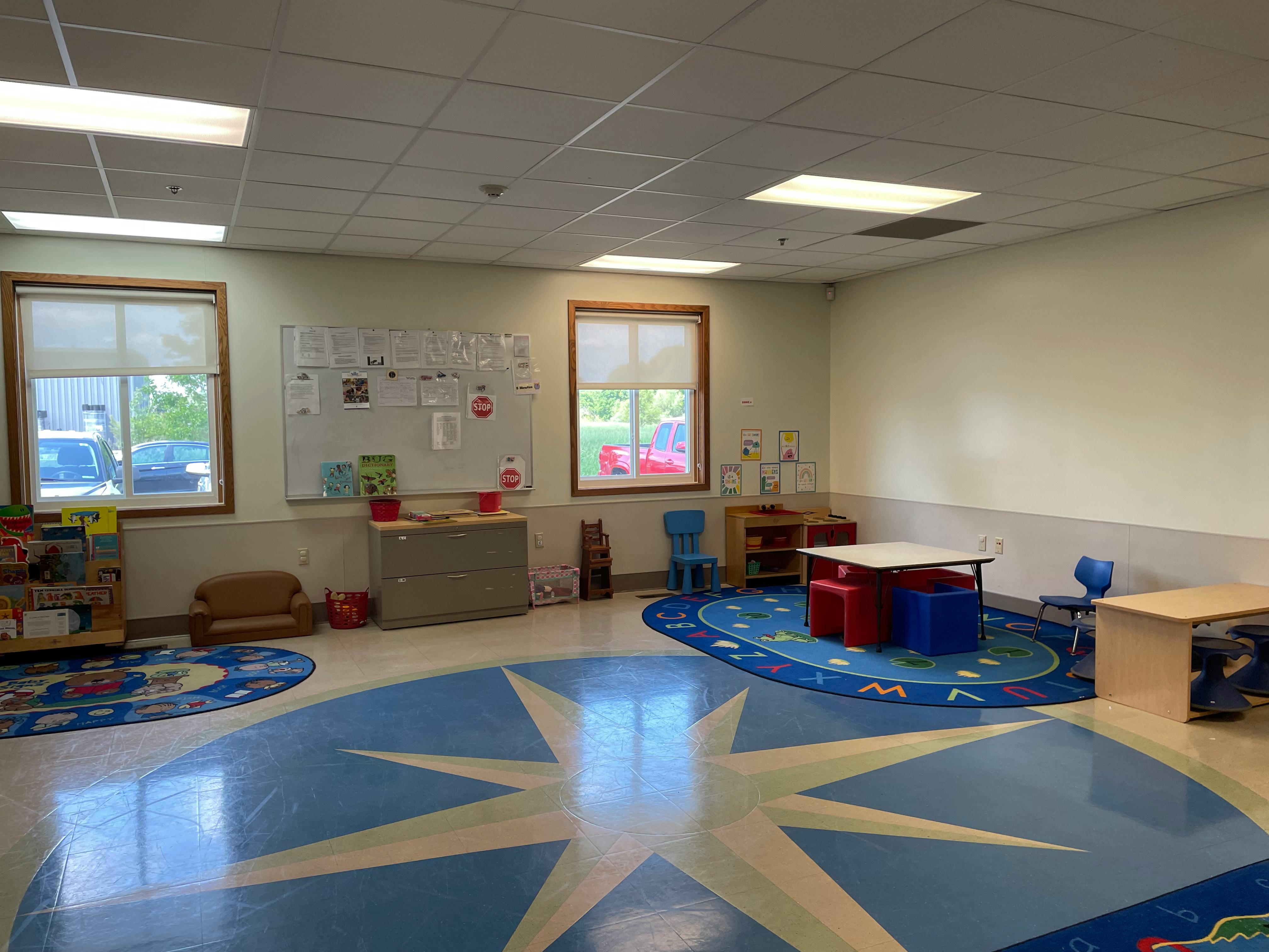 Empty classroom with small tables and chairs