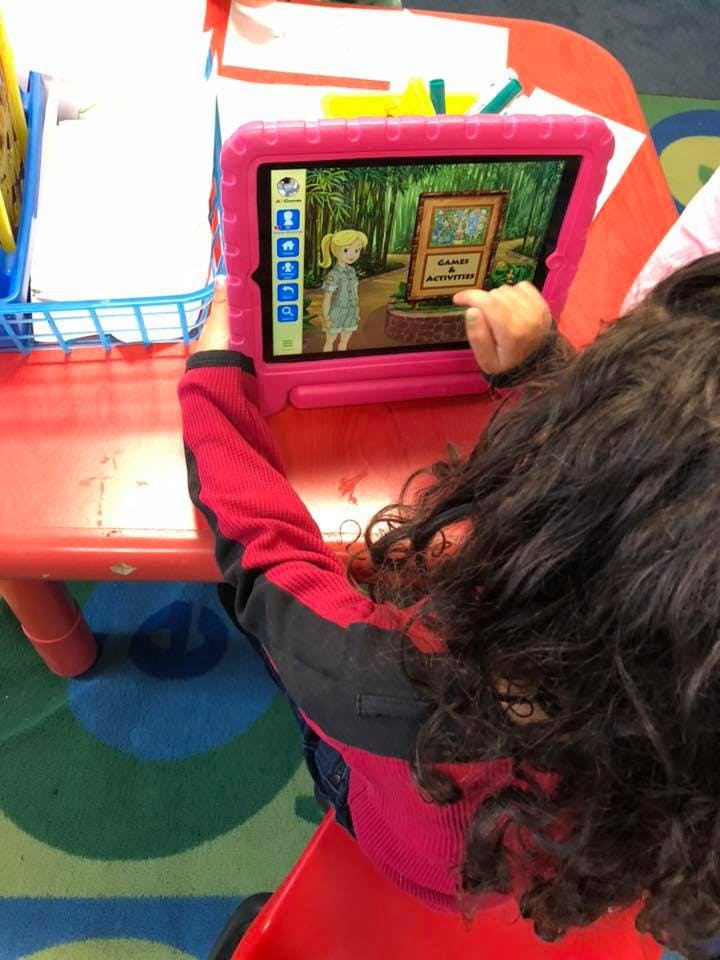 Child using a tablet with an animated character on screen