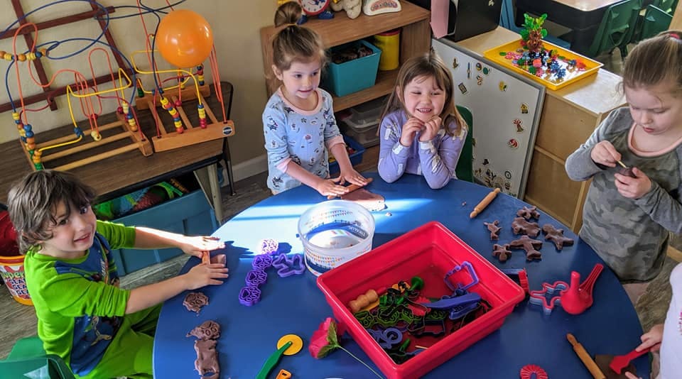 Children playing with toys at a table